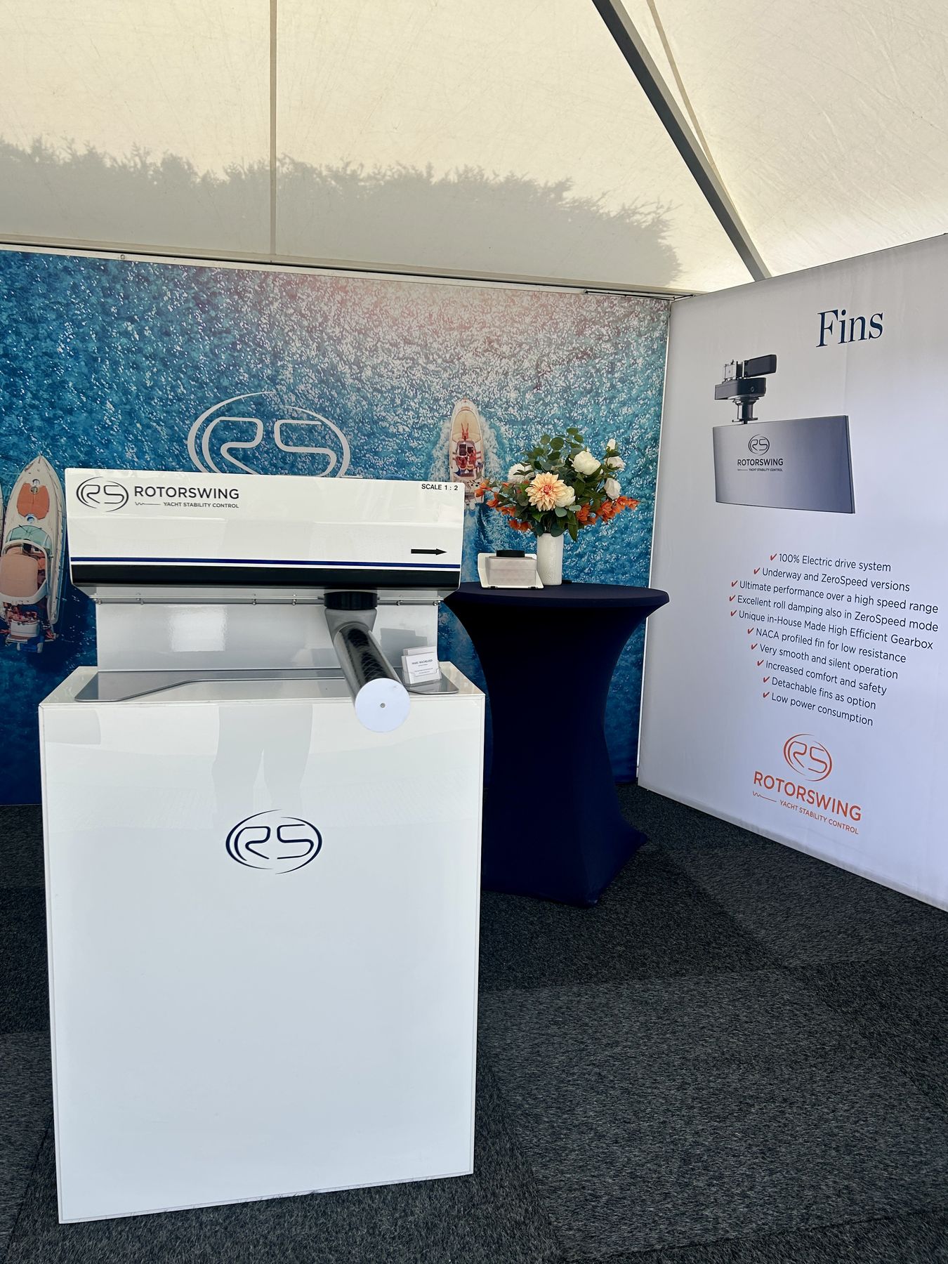 The RotorSwing display at Motorboot Sneek: a rotor on a white plinth beside a panel about the fin stabilizers