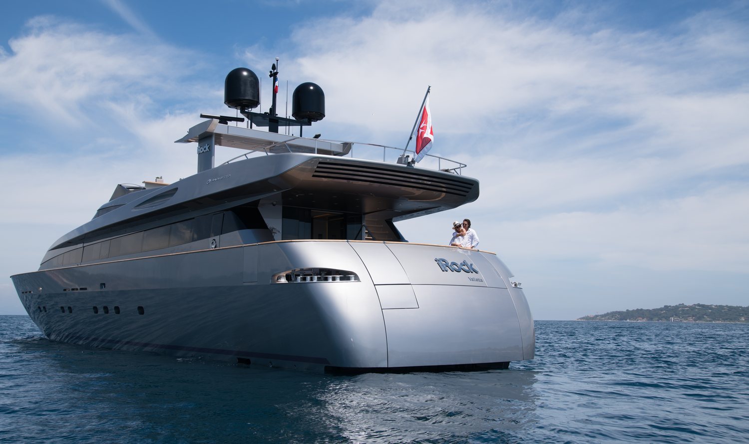 MY iRock lying at anchor in calm water with guests on the aft deck