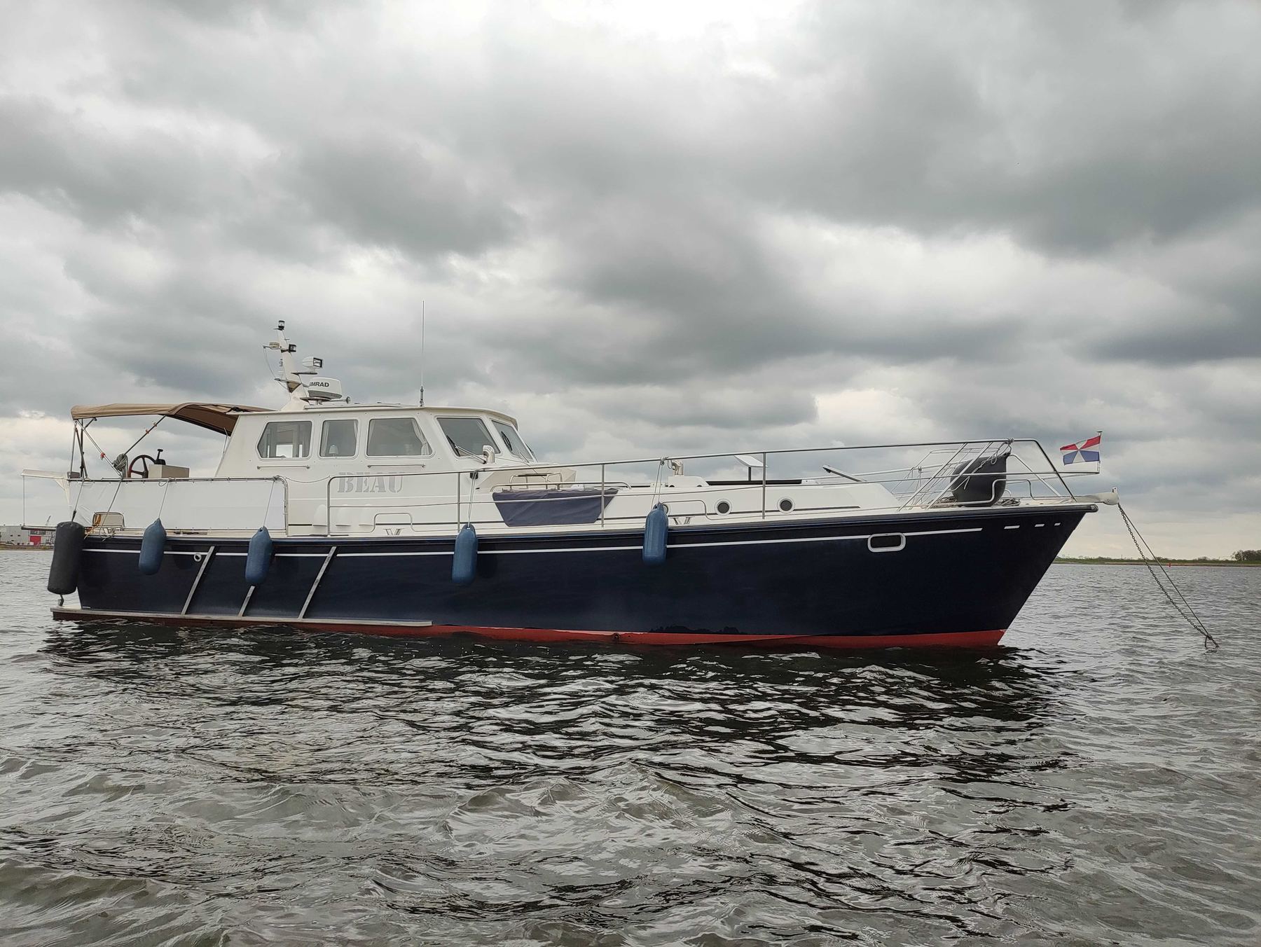 MY Beau lying at anchor in a sheltered bay