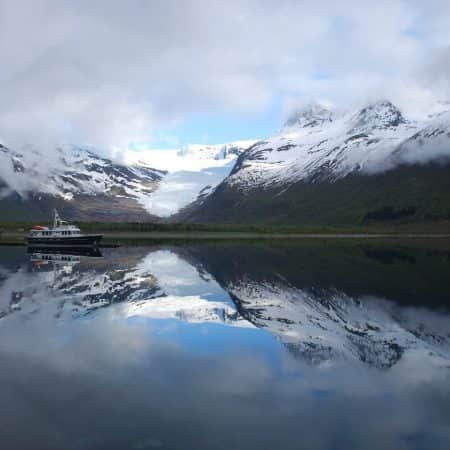 MY VRYBURG lying still in a mirror-calm Norwegian fjord below a glacier