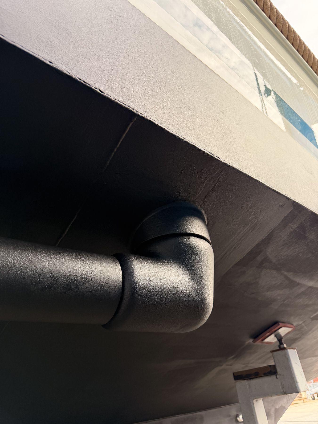 A rotor folded up against the hull, the arm running close along the plating