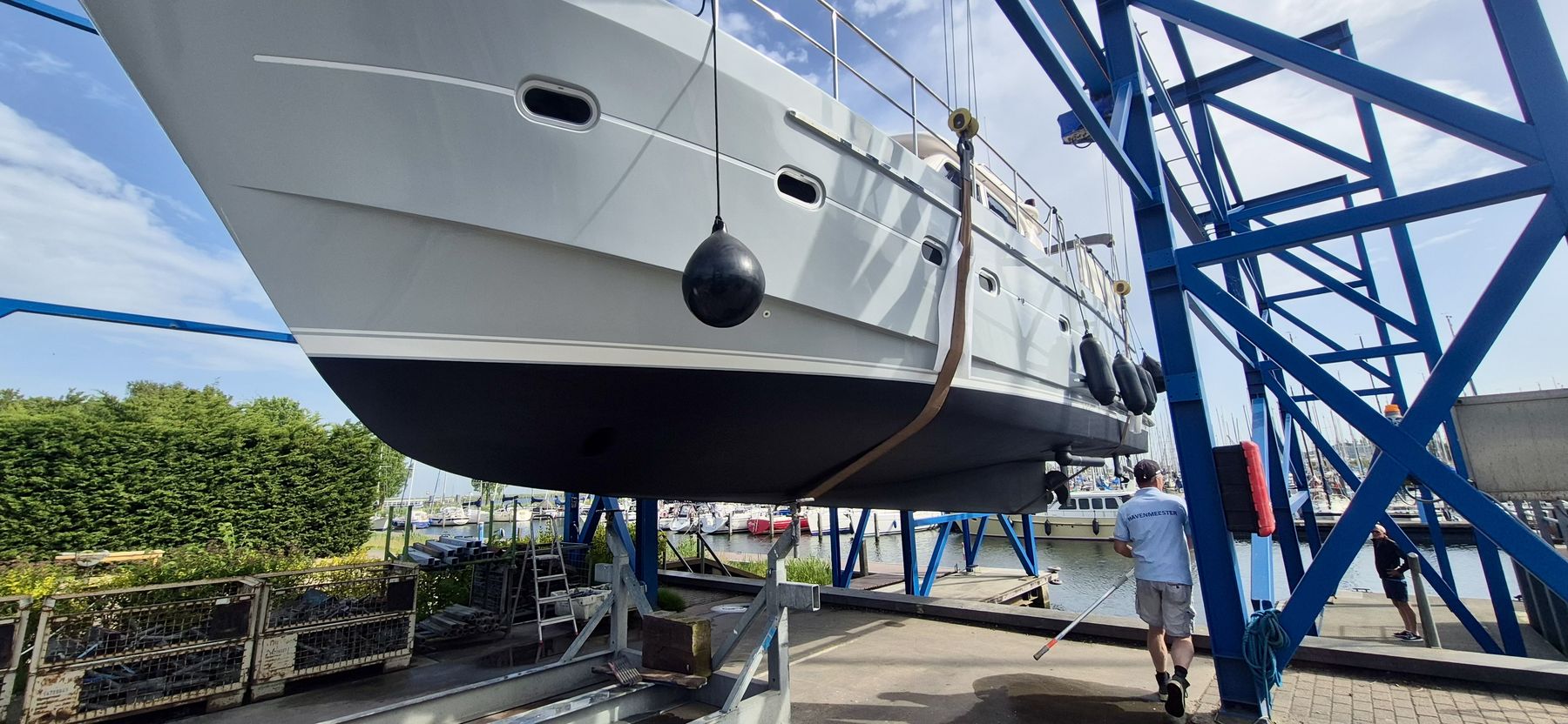 A motor yacht in the frame of a travel lift, seen from the bow